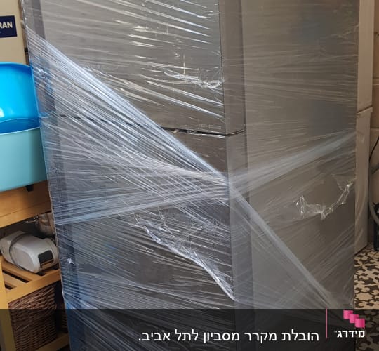 מקרר עטוף בניילון נצמד, מוכן להובלה